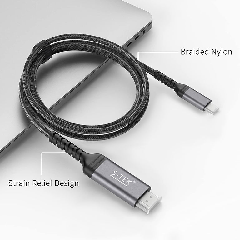 S-TEK USB-C to HDMI cable shown coiled beside a laptop, highlighting its braided nylon jacket and strain relief.